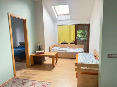 a bedroom with two beds and a window at K-Town - Cozy Apartment Near the City Center in Kaunas