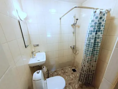 a bathroom with a toilet and a sink and a shower at K-Town - Cozy Apartment Near the City Center in Kaunas