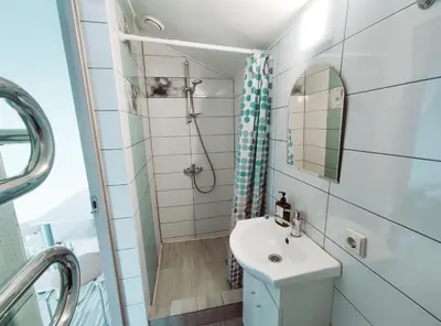 a small bathroom with a sink and a mirror at K-Town - Cozy Apartment Near the City Center in Kaunas