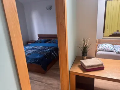 a door leading into a bedroom with a bed at K-Town - Cozy Apartment Near the City Center in Kaunas