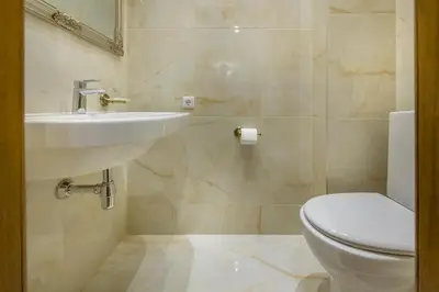 a bathroom with a sink and a toilet at Kesminta Apartments in Vilnius