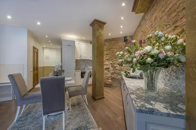 a kitchen with a table with a vase of flowers at Kesminta Apartments in Vilnius