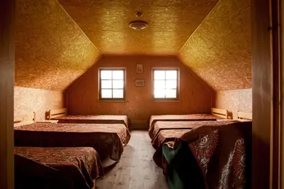 a room with four beds and two windows at Adomo Sodyba in Dubingiai