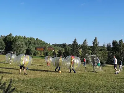 a group of people dressed in inflatable spheres playing soccer at Adomo Sodyba in Dubingiai