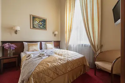 a hotel room with a bed and a window at Conviva in Panevėžys