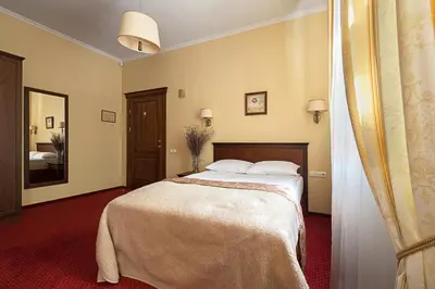 a bedroom with a bed and a mirror at Conviva in Panevėžys