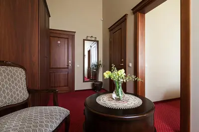 a room with a vase of flowers on a table at Conviva in Panevėžys