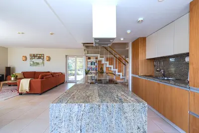a kitchen with a table in the middle of a room at Domido Villa in Trakai
