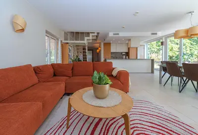 a living room with a orange couch and a table at Domido Villa in Trakai