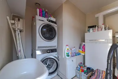 a laundry room with a washing machine and a washer at Domido Villa in Trakai