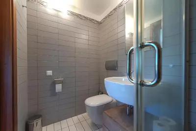 a bathroom with a toilet and a sink at Domido Villa in Trakai