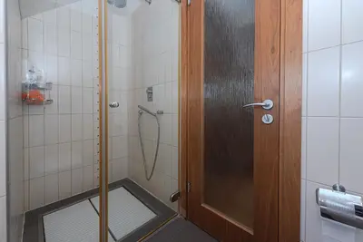 a shower with a glass door in a bathroom at Domido Villa in Trakai