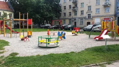 a playground with different colored play equipment in a park at Old Town Apartment Antokolskio in Vilnius