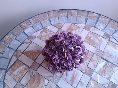 a bouquet of purple roses sitting on a table at Kernavės centras in Kernavė