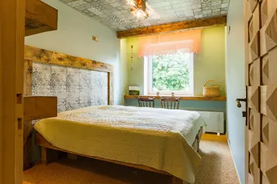 a bedroom with a bed and a window and a table at Kernavės centras in Kernavė