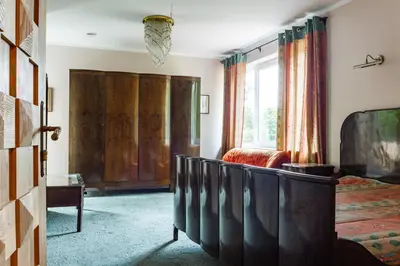 a bedroom with a bed and a large window at Kernavės centras in Kernavė
