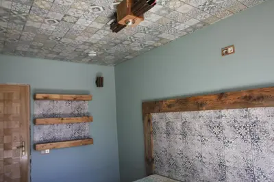 a room with a ceiling fan and a room with a bed at Kernavės centras in Kernavė