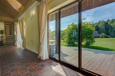 an empty room with sliding glass doors and a patio at Spacious Villa with Large Hall in Mindūnai