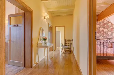 a hallway with a table and a room with a bed at Spacious Villa with Large Hall in Mindūnai