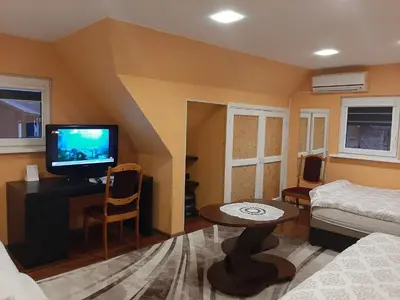 a small living room with a tv and a couch at Prie Ąžuolo in Zarasai