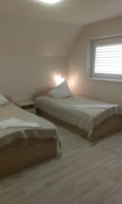 two beds in a room with a window at Prie Ąžuolo in Zarasai
