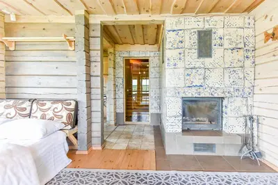 a living room with a fireplace and a couch at Vila Tauragnas in Varniškės I