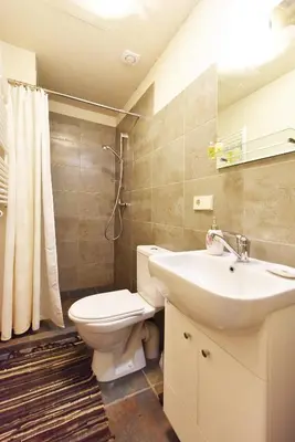 a bathroom with a toilet and a sink at Vila Tauragnas in Varniškės I