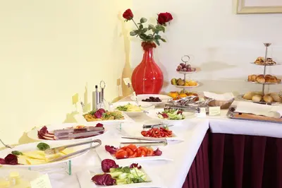 a buffet with many plates of food on a table at Smėlynė in Panevėžys