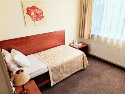 a hotel room with a bed and a window at Smėlynė in Panevėžys