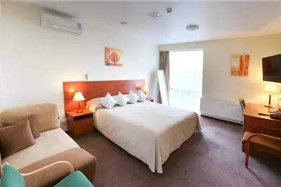 a hotel room with a bed and a couch at Smėlynė in Panevėžys
