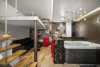 a bathroom with a hot tub in the middle of a room at Secret Lounge - Cozy Studio with Sauna and Jacuzzi in Vilnius