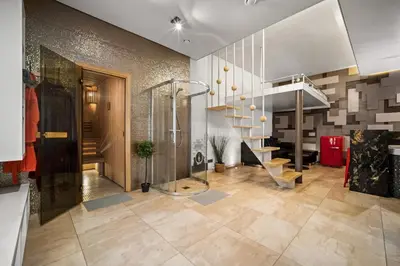 a lobby with a staircase and a stair case at Secret Lounge - Cozy Studio with Sauna and Jacuzzi in Vilnius