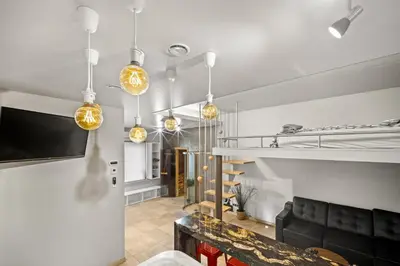 a living room with a couch and some lights at Secret Lounge - Cozy Studio with Sauna and Jacuzzi in Vilnius