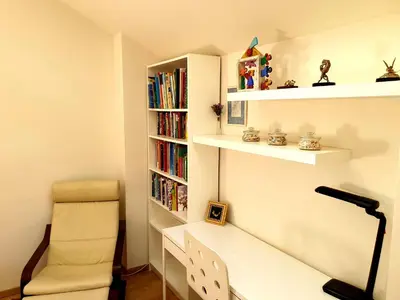 a room with a desk and a chair and bookshelves at Exceptional Uzupis Bridge 3 bedroom apartment in Vilnius