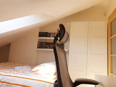 a room with a bed and a desk and a chair at Exceptional Uzupis Bridge 3 bedroom apartment in Vilnius