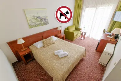 a small bedroom with a bed and a no swimming sign at Regina in Druskininkai