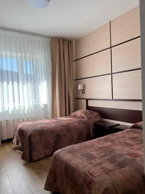 a hotel room with two beds and a window at Via Baltica in Sargėnai
