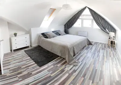 a bedroom with a bed and a large window at Cathedral Sq. Apartment - Odminiu Str. in Vilnius