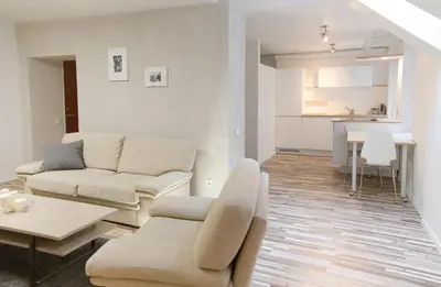 a living room with a couch and a table at Cathedral Sq. Apartment - Odminiu Str. in Vilnius