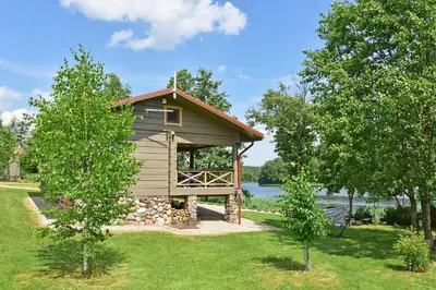 a cabin in the middle of two trees at Mekų slėnis in Degučiai