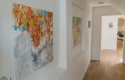 a painting hanging on a wall in a room at Baron's Arthouse Apartment in Vilnius