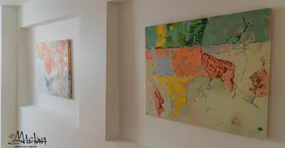 two pieces of art hanging on a wall at Baron's Arthouse Apartment in Vilnius