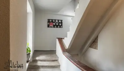 a staircase in a house with white walls at Baron's Arthouse Apartment in Vilnius