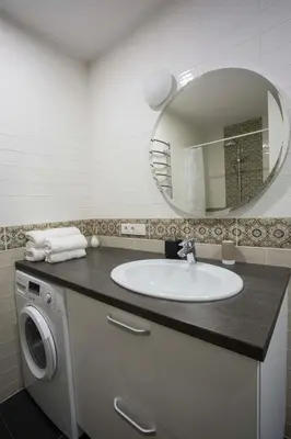 a bathroom with a sink and a mirror at Baron's Town Hall Apartments in Vilnius