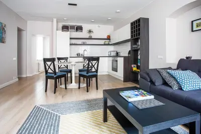 a living room with a couch and a table at Baron's Town Hall Apartments in Vilnius