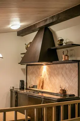 a kitchen with a stove top oven in a room at Rest ART in Anykščiai