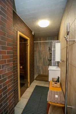 a bathroom with a brick wall and a sink and a shower at Rest ART in Anykščiai