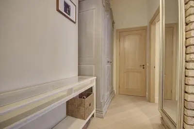 a hallway with a white room with a door at Town Hall Square Apartments in Vilnius