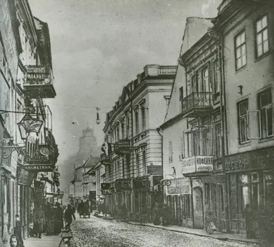 an old photo of a city street with buildings at Town Hall Square Apartments in Vilnius