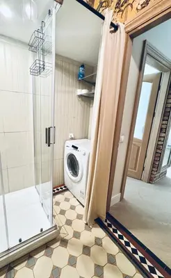 a laundry room with a washing machine in a bathroom at Town Hall Square Apartments in Vilnius